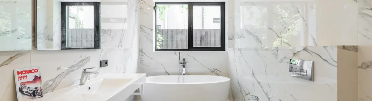 Frameless walk-in shower with large-format porcelain tile and linear drain