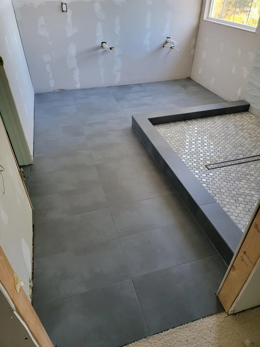 Walk-in shower with custom tile work and frameless glass door