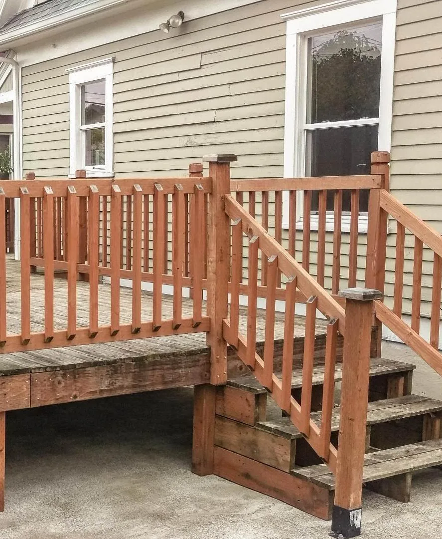Pressure-treated wood deck with classic white railing on Virginia home